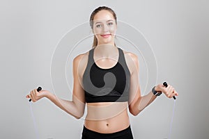 Athletic woman holding a rope