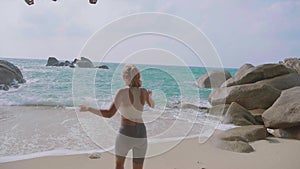 Athletic Woman Jogging Along the Beach