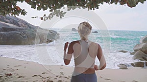 Athletic Woman Jogging Along the Beach