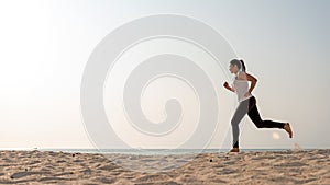 Athletic woman jogging exercise and relax and freedom on sand beach.