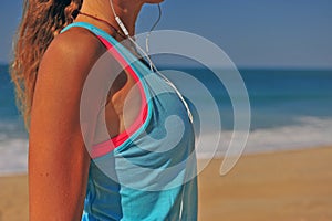 Athletic woman listening to music outdoors