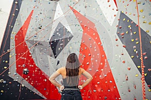 Athletic woman preparing for rope climbing exercise at the local gym b