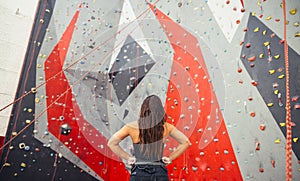 Athletic woman preparing for rope climbing exercise at the local gym b