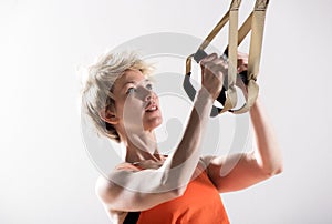 Athletic woman pulling fitness cords