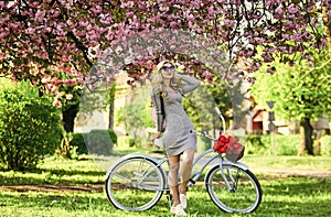 Athletic woman ride retro bicycle. Rest and travel. Travel by bike. Weekend concept. Spring holidays. Riding bicycle