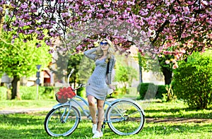Athletic woman ride retro bicycle. Rest and travel. Travel by bike. Weekend concept. Spring holidays. Riding bicycle