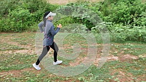 Athletic woman running on forest trail. Female runners running in nature in the morning. Workout Healthy lifestyle concept.