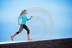 Athletic woman running jogging outside