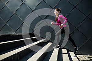 Athletic woman running up stairs during cardio. interval training