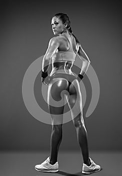 Athletic woman showing muscles of the back