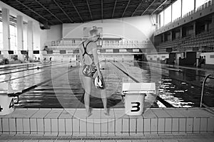 Athletic woman standing in front of pool