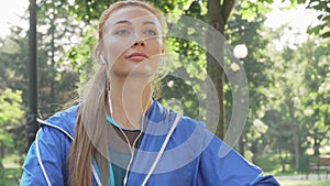 Athletic woman stretching in the park before her morning workout