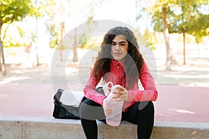 Athletic woman taking a break during her workout training outdoors