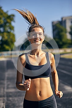 Athletic woman on track starting to run