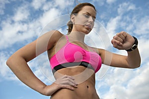 Athletic woman using heart rate monitor