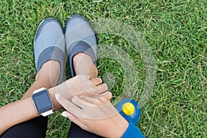 Athletic woman using smartwatch on top