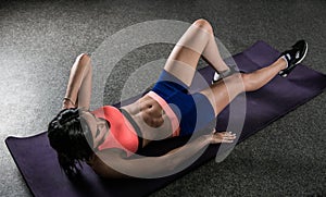 Athletic woman working ab intervals in fitness.