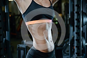 athletic young girl training abs in gym
