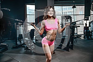 athletic young girl training arms in gym