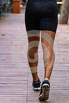 Athletic young man doing a morning jog in a city park on the nature. Concept, healthy lifestyle