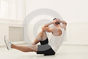 Athletic young man doing sit-ups