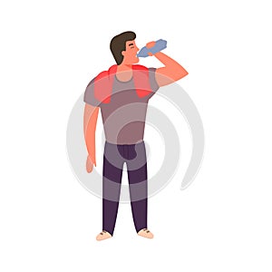 Athletic young man is drinking water from a bottle