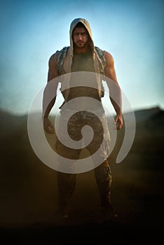 Athletic young man on dusty field