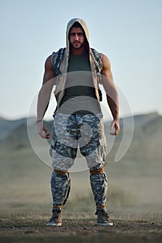 Athletic young man on dusty field