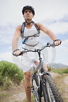 Athletic young man mountain biking