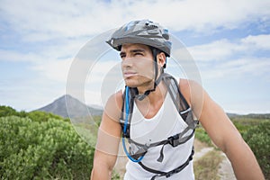 Athletic young man mountain biking