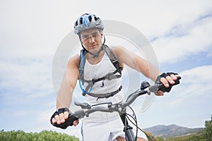 Athletic young man mountain biking