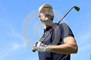 Athletic young man playing golf in golfclub