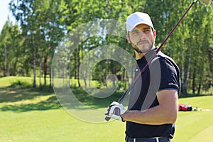 Athletic young man playing golf in golfclub