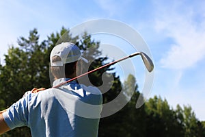 Athletic young man playing golf in golfclub