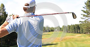 Athletic young man playing golf in golfclub