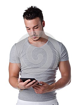 Athletic young man reading book on ebook reader