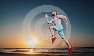 Athletic young man running. Healthy lifestyle concept. Dynamic jumping movement. Sport and healthy lifestyle.