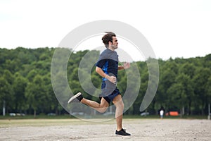 Athletic young man running outdoors