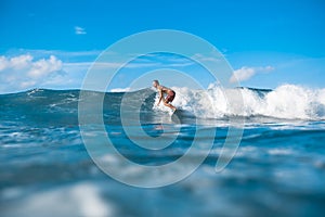 athletic young man surfing