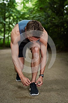 Athletic Young Man Tying his Shoelace