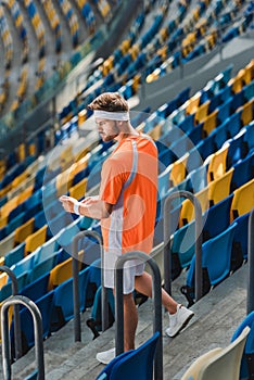 athletic young man walking downstairs on stairs