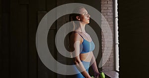 Athletic young woman doing a sport fitness workout with dumbbells at gym