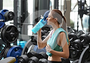 Athletic young woman drinking protein shake