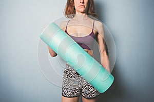 Athletic young woman with foam roller