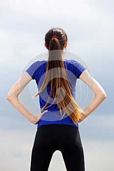 Athletic young woman with hands on hips