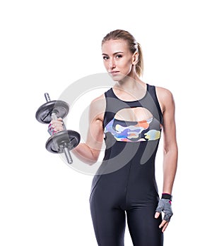 athletic young woman with perfect strong muscular body wearing sportswear tracksuit pumping up muscles with dumbbells.