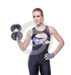 athletic young woman with perfect strong muscular body wearing sportswear tracksuit pumping up muscles with dumbbells isolate