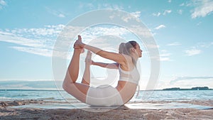 athletic young woman practicing yoga. Compass pose , fold , hamstring stretch.