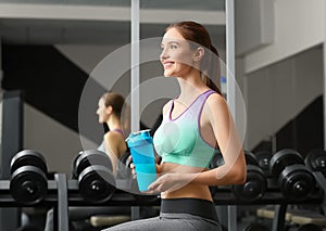 Athletic young woman with protein shake