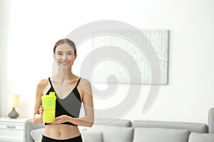 Athletic young woman with protein shake